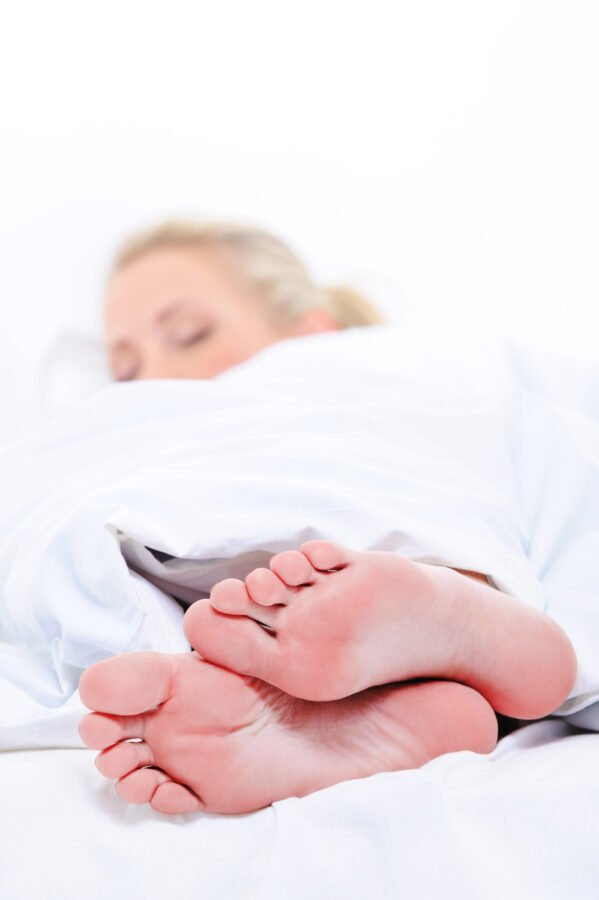 foreground-close-up-clean-feets-pretty-woman-sleep-cover-white-blanket