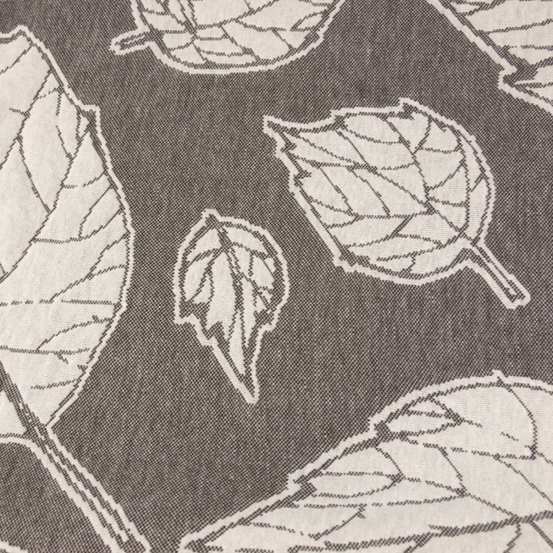 Narzuta z motywem roślinnym beżowych liści na brązowym tle - zbliżenie
