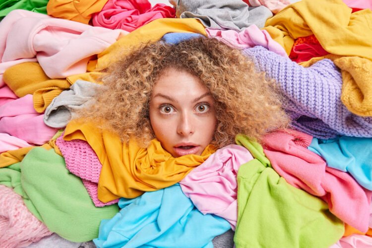 wardrobe-arrangement-womans-head-sticking-through-pile-colorful-clothes-involved-old-belongings-charity-takes-part-humanitarian-aid-organization-female-gathers-garments-needy-people (1) (1)